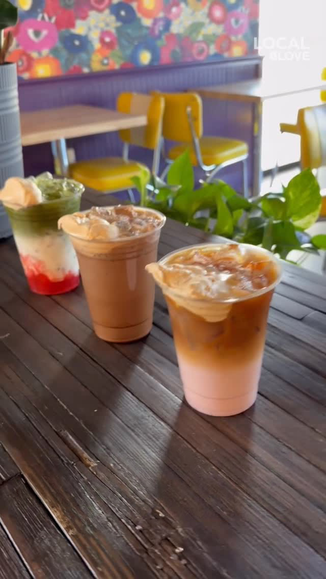 Three specialty drinks on a wooden table