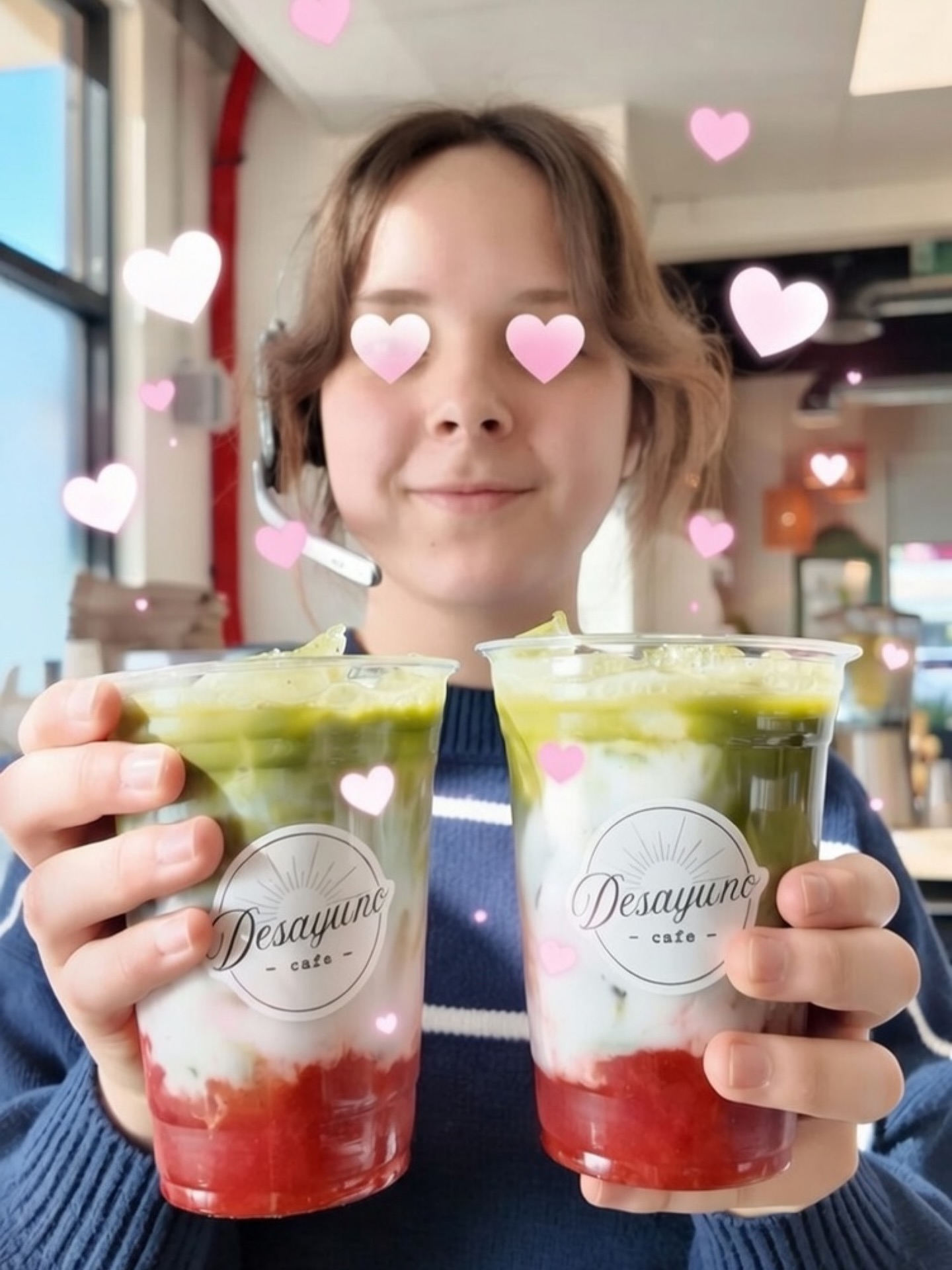 Guest holding two strawberry matcha drinks