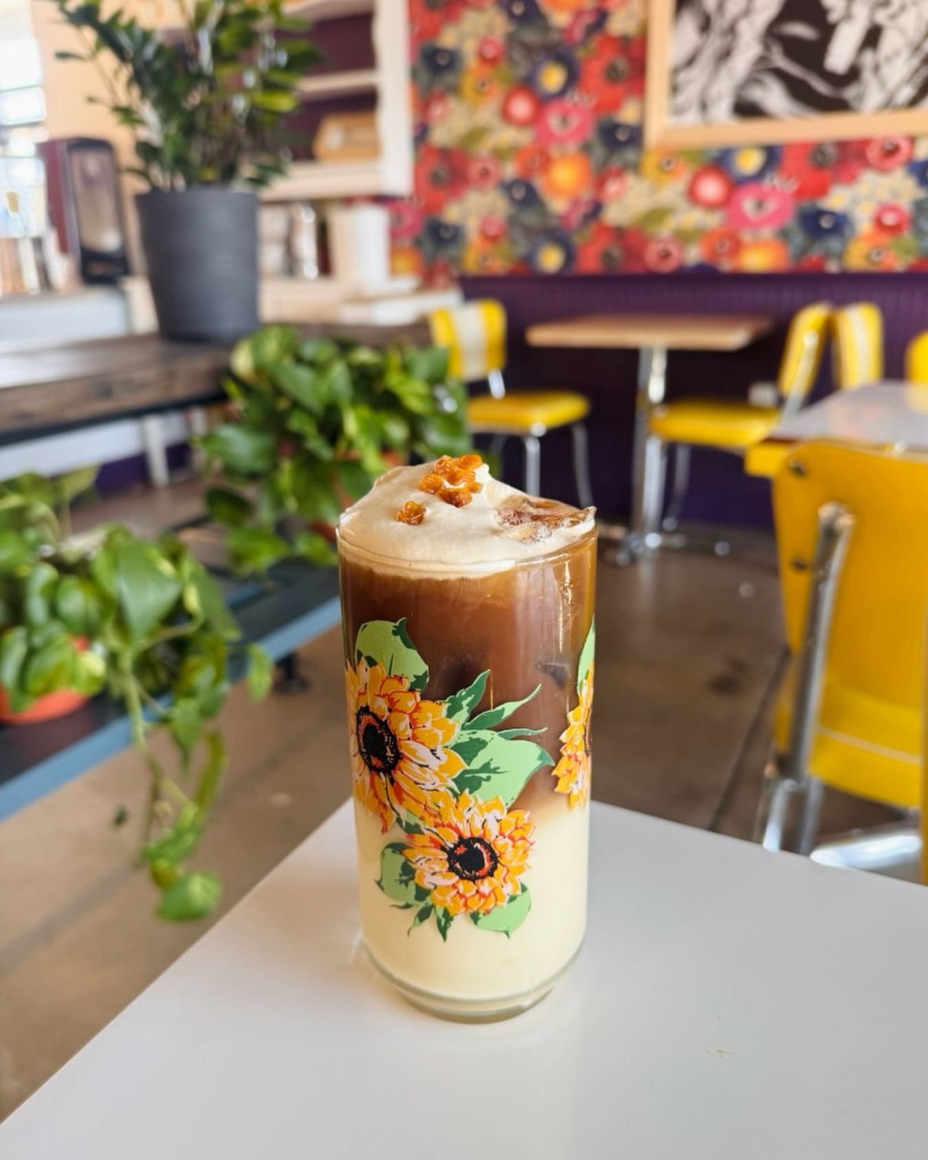 Iced latte in a sunflower-print cup on the Instagram feed